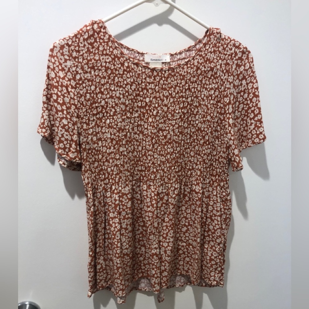 Rust and cream colored babydoll top with leopard print.